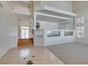 Bright, open-concept living area featuring neutral tones, plush carpeting, and large windows for natural light at 6 High Sierra Dr, Henderson, NV 89074