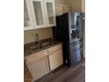 Kitchen features stainless steel refrigerator, granite counters and white cabinets at 6480 Annie Oakley Dr # 112, Las Vegas, NV 89120