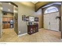 Inviting entryway featuring tile floors, an arched ceiling, and a decorative console table at 6712 Tattler Dr, North Las Vegas, NV 89084