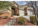 Close up of a single-story home featuring a well-manicured front yard and a two-car garage at 6712 Tattler Dr, North Las Vegas, NV 89084