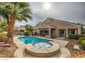 Backyard pool and hot tub surrounded by a fenced in yard, perfect for entertaining and relaxation at 6712 Tattler Dr, North Las Vegas, NV 89084