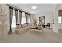Elegant living room featuring neutral tones, stylish decor, and bright natural light at 6739 Quapaw St, Las Vegas, NV 89149