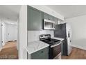 A stylish kitchen is showcased with stainless steel appliances, modern cabinetry, and elegant countertops at 728 Carpenter Dr, Las Vegas, NV 89107