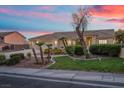 Attractive one-story home with manicured lawn and palm trees under a vivid sunset sky at 835 Market Crest Dr, Las Vegas, NV 89110