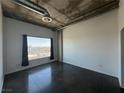 Bedroom with concrete ceilings offers natural light and a view of the city at 900 Las Vegas Blvd # 1003, Las Vegas, NV 89101