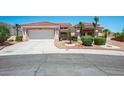 Inviting single-story home with a well-manicured lawn, desert landscaping, and an attached two-car garage at 10720 Bennington Ct, Las Vegas, NV 89134