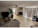 Spacious living room with tile floors, a fireplace, and sliding glass doors providing ample light at 10968 Geyser Peak St, Henderson, NV 89052