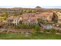 Beautiful exterior view of residences overlooking meticulously maintained green space, pool, and community gazebo at 11 Via Vita Bella, Henderson, NV 89011