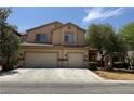 Two-story home featuring a spacious three-car garage and desert landscaping at 11457 Steponia Bay St, Las Vegas, NV 89141