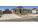 Charming home features a two-car garage and an RV garage, complemented by tasteful stone accents at 130 W Fairway Rd, Henderson, NV 89015
