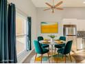 Cozy dining area featuring stylish decor, modern lighting, and stainless steel appliances in the kitchen at 1308 Capri Dr # D, Boulder City, NV 89005
