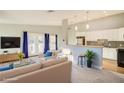 Inviting living room with light-colored walls and plush carpet adjacent to a stylish, modern kitchen at 1308 Capri Dr # D, Boulder City, NV 89005