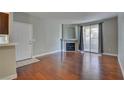 Living room featuring hardwood floors, neutral walls, fireplace, and glass doors to balcony at 1405 S Nellis Blvd # 2117, Las Vegas, NV 89104