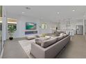 Open-concept living room featuring a sleek fireplace and seamless connection to the modern kitchen at 164 Cabo Cruces Dr, Henderson, NV 89011