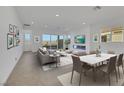 Bright living room with large windows, contemporary furniture, and an electric fireplace at 164 Cabo Cruces Dr, Henderson, NV 89011