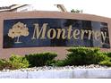 Monterey community sign featuring a tree and gold lettering, set against desert landscaping at 1721 Mill Canyon Dr, Las Vegas, NV 89128