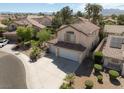 Aerial view showcasing a charming desert home with a tile roof and mature landscaping at 1721 Mill Canyon Dr, Las Vegas, NV 89128