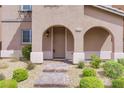 Attractive home entrance with brick pathway and covered archway at 1976 Galleria Spada St, Henderson, NV 89044