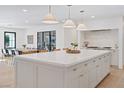 Bright, modern kitchen with a large center island, stylish pendant lighting, and stainless steel appliances at 204 Canyon Dr, Las Vegas, NV 89107