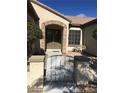 Beautiful home entryway featuring a stone archway and gated front porch at 2175 Clearwater Lake Dr, Henderson, NV 89044