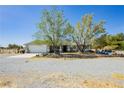 Attractive single-story home with a gravel yard and inviting outdoor seating area at 2251 Bridger St, Pahrump, NV 89048