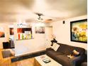 Cozy living room with wood floors, ceiling fan, and view into kitchen at 2451 N Rainbow Blvd # 2073, Las Vegas, NV 89108