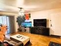 Bright living room features wood floors, a front door, and sliding glass doors at 2451 N Rainbow Blvd # 2073, Las Vegas, NV 89108