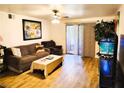 Relaxing living room with wood floors, sliding glass doors, and comfortable seating at 2451 N Rainbow Blvd # 2073, Las Vegas, NV 89108