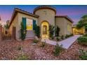 Inviting home exterior featuring a stone walkway, mature landscaping, and a decorative entryway at 2921 Guillemot Ave, North Las Vegas, NV 89084
