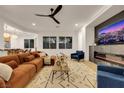 Bright living room featuring a comfortable sectional sofa, contemporary fireplace, and large windows at 2921 Guillemot Ave, North Las Vegas, NV 89084