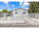 Picture of the house, showcasing its fenced perimeter, well-maintained yard, and inviting front entrance at 320 W Van Buren Ave, Las Vegas, NV 89106