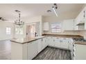 Updated kitchen with white cabinetry, modern fixtures, and breakfast bar offers great space at 3820 Wiggins Bay St # 201, Las Vegas, NV 89129
