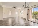 Bright, open living area features modern light fixture, balcony, and updated ceiling fan at 3820 Wiggins Bay St # 201, Las Vegas, NV 89129