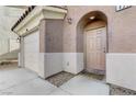 A close up of the front door showing the covered entry and attached garage at 439 Royal Bridge Dr, Las Vegas, NV 89178
