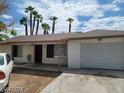 Modest one-story home with brick accents, covered front porch, and a single-car attached garage at 45 Logan Ct, Las Vegas, NV 89110