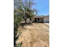 View of the front of a one-story home with a large tree in the front yard at 45 Logan Ct, Las Vegas, NV 89110