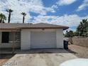 View of the exterior of the home showing the one car garage with a white garage door at 45 Logan Ct, Las Vegas, NV 89110