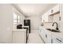 Bright kitchen featuring white cabinets and modern black appliances at 4558 Sheppard Dr, Las Vegas, NV 89122