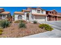 Charming two-story home with a well-manicured lawn and a two-car garage, offering great curb appeal at 4615 Stearman Dr, North Las Vegas, NV 89031