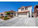 Charming two-story home with a well-manicured lawn and a two-car garage, offering great curb appeal at 4615 Stearman Dr, North Las Vegas, NV 89031