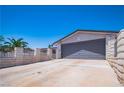 Home showcasing a large garage and wide driveway, with gated entry, and mature landscaping at 4742 Monterrey Ave, Las Vegas, NV 89121