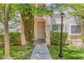 Charming condo entrance with well-maintained greenery, sidewalk, and a welcoming light fixture at 4843 S Torrey Pines Dr # 101, Las Vegas, NV 89103