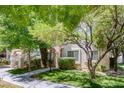 Attractive condo exterior with mature trees, manicured lawns, and a pleasant walking path at 4843 S Torrey Pines Dr # 101, Las Vegas, NV 89103
