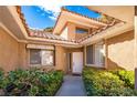 Beautifully landscaped front entrance featuring a white door, sidelight windows, and manicured shrubbery at 4911 Mount Pleasant Ln, Las Vegas, NV 89113
