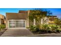 Home featuring an attached garage with a modern see-through door, brick driveway and desert foliage at 507 Serenity Point Dr, Henderson, NV 89012