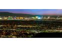 The Las Vegas skyline at night with all of the lights lit up behind a residential area at 507 Serenity Point Dr, Henderson, NV 89012