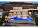 Spectacular backyard pool with a built-in fire pit, lounge area, and modern design elements perfect for outdoor entertaining at 507 Serenity Point Dr, Henderson, NV 89012