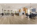 Open floor plan with living, kitchen and dining areas, hardwood floors and recessed lighting at 5157 Future Dr, Las Vegas, NV 89130