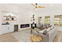 Cozy living room featuring a modern fireplace, stylish furniture, and lots of natural light at 5157 Future Dr, Las Vegas, NV 89130