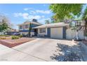 View of the home's front exterior, highlighting the driveway, garage, and inviting curb appeal at 5505 Reiter Ave, Las Vegas, NV 89108